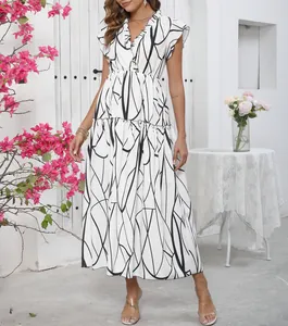 Detail view of the V-neck ruffled neckline and abstract print on this white maxi dress