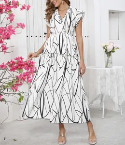 Detail view of a white maxi dress with black abstract print and ruffle V-neckline.