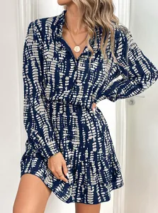 Close-up of a stylish blue and white patterned long-sleeved dress with ruffled hem detail