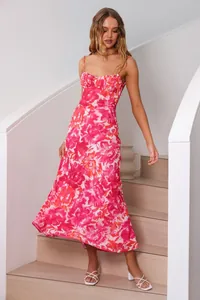 Elegant pink floral maxi dress featuring thin spaghetti straps and a sexy low-cut back design.