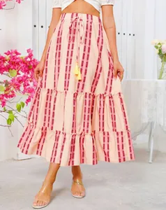 Detail view of Bohemian striped maxi skirt featuring tiered ruffles and yellow tassels
