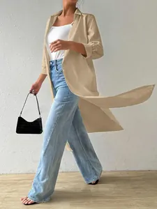 Side view of women's long beige cardigan shirt styled with wide-leg jeans