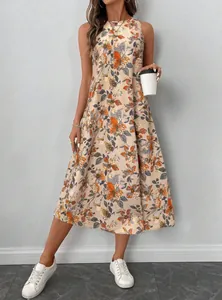 Full-length view of a beige floral print sleeveless midi dress with white sneakers