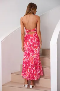Elegant back view of pink floral backless maxi dress with spaghetti straps on stairs
