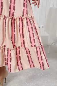 Detail view of bohemian printed maxi skirt showing tiered ruffle hem and stripe pattern