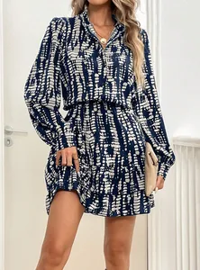 Detail view of a stylish blue and white printed long-sleeve mini dress with ruffles.
