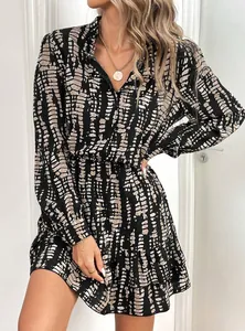 Detailed shot of woman wearing a stylish long-sleeved V-neck ruffled dress with pattern