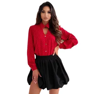 Elegant red polka dot rhinestone V-neck long sleeve blouse for women in a studio shot.