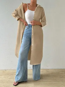 Stylish khaki long-sleeved oversized button-up shirt worn over white tank top and jeans