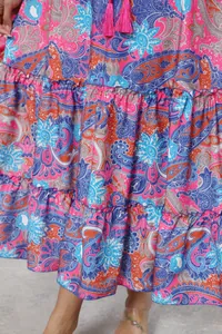 Detailed close-up of vibrant bohemian paisley print on a tiered maxi vacation skirt