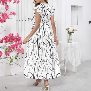 Back view of elegant white maxi dress with black abstract print and ruffled hemline