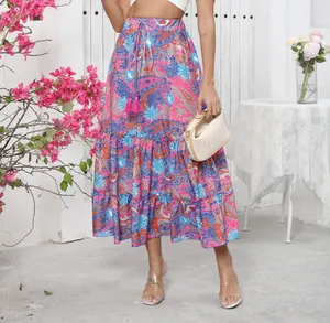 Detail of a Bohemian floral print maxi skirt with tiered hem and tassel drawstring.
