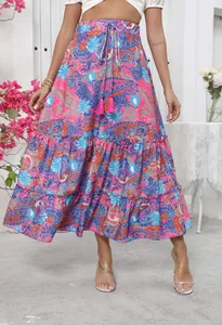 Detail of bohemian paisley print maxi skirt with tiered hem and drawstring tassel waist.