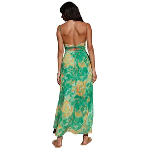 Back view of a green floral maxi dress with thin straps and a chic open back design.