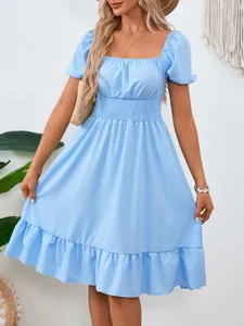 Elegante abito azzurro con maniche a sbuffo, vita a nido d'ape e orlo a volant