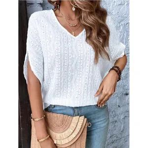 Chic white V-neck short-sleeve top with geometric eyelet texture in a trendy boho style
