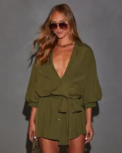 Close-up detail of stylish olive green shirt dress with deep V-neck and waist tie belt