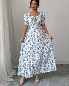 Full view of a white floral maxi dress featuring a ruffle neckline and tied front detail