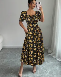 Detail view of elegant black floral midi dress with puff sleeves and square neckline.