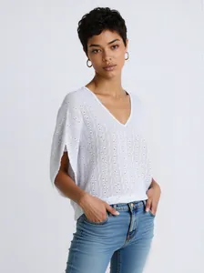 Detail view of a white V-neck knitted top featuring elegant texture and loose-fit sleeves