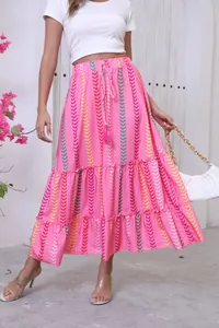 Detail of bohemian pink printed maxi skirt with tiered ruffles and tassel drawstring