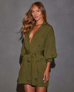 Detail of olive green long-sleeved shirt dress with elegant tie-waist design
