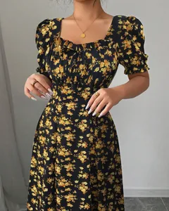 Detail view of an elegant black floral ruffle short sleeve dress with a square neck.