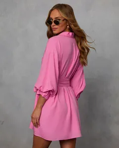 Detailed back view of a stylish pink long-sleeved shirt dress featuring a waist tie