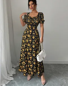 Elegant black and yellow floral maxi dress with ruffled square neck and short sleeves