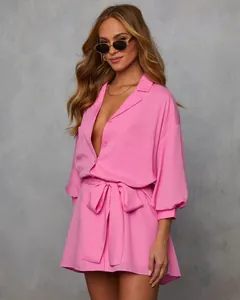 Front view detail of a vibrant pink shirt dress with elegant waist tie and collar.