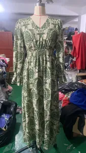 Vintage green damask print V-neck long sleeve maxi dress on mannequin in workshop view.