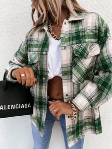Detailed view of a vintage green plaid long-sleeved shirt jacket with chest pockets