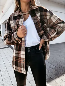 Close-up detail of a retro plaid shirt jacket with long sleeves and button closure