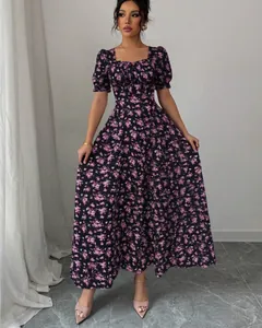 Front view of an elegant purple floral maxi dress with puff sleeves on a model in a studio
