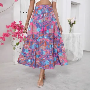 Summer bohemian tiered maxi skirt with vibrant paisley print and drawstring waist tassels