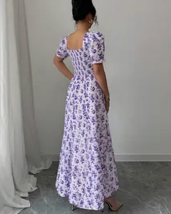 Back view of elegant purple floral maxi dress featuring a smocked bodice and short sleeves