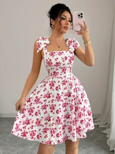 Detailed view of floral A-line dress with elegant bow straps on model