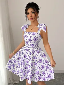 Detailed view of women's purple floral summer dress with bow-tie shoulder straps