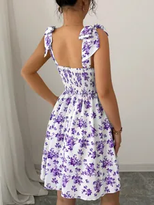 Rear detail of a purple floral tie-shoulder backless dress with a smocked bodice.