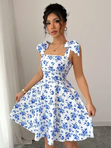 Detailed view of white and blue floral dress with elegant shoulder tie straps