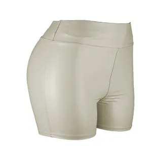 Detail view showing the side profile of high-waisted beige PU leather hot pants