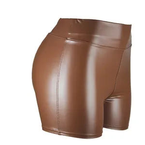 Close-up detail showing the texture and stitching of brown high-waisted PU leather hot pants