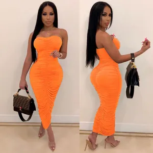 Elegant model wearing a bright orange milk silk ruched bodycon tube midi dress