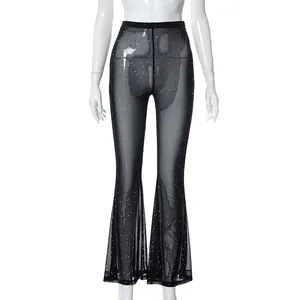 Close-up detail view of sexy black sheer mesh flared trousers with sparkling silver sequins