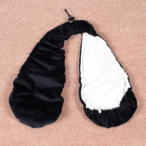 Soft black towel bra with halter drawstring and white absorbent lining on textured background.
