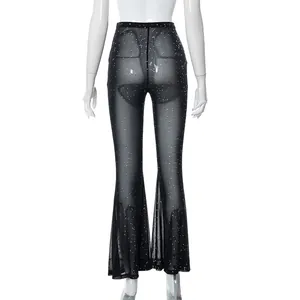 Back view of sexy black sheer mesh flared pants with silver glitter and high waist.