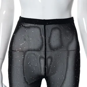 Detail view of sexy black mesh sheer pants with glitter accents and elastic waist