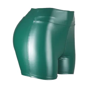 Detailed view of high-waist green PU leather shorts showing material texture and fit.