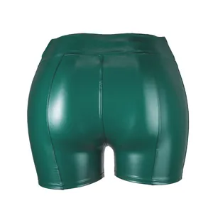 Close-up back view of sexy high-waisted green PU leather shorts for women's club wear