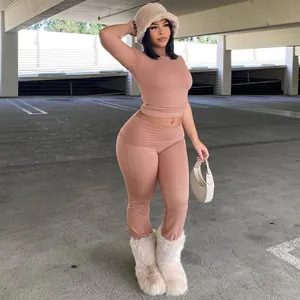 Trendy two-piece nude set featuring slim fit crop top and matching tight flare leggings